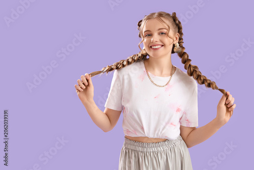 Canvas Print Happy smiling young woman with braids on lilac background