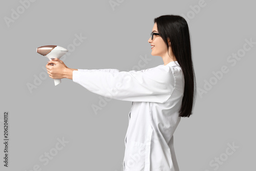 Happy young beautician with...