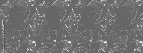 Tableau sur toile Plastic wrap Wrinkled plastic wrap texture on a black background