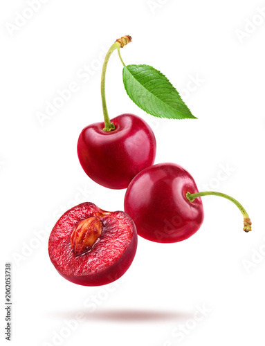 Red cherries with half cut isolated on white background.