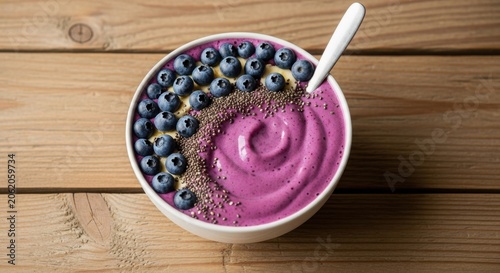Healthy Purple Smoothie Bowl Topped With Blueberries and Seeds.