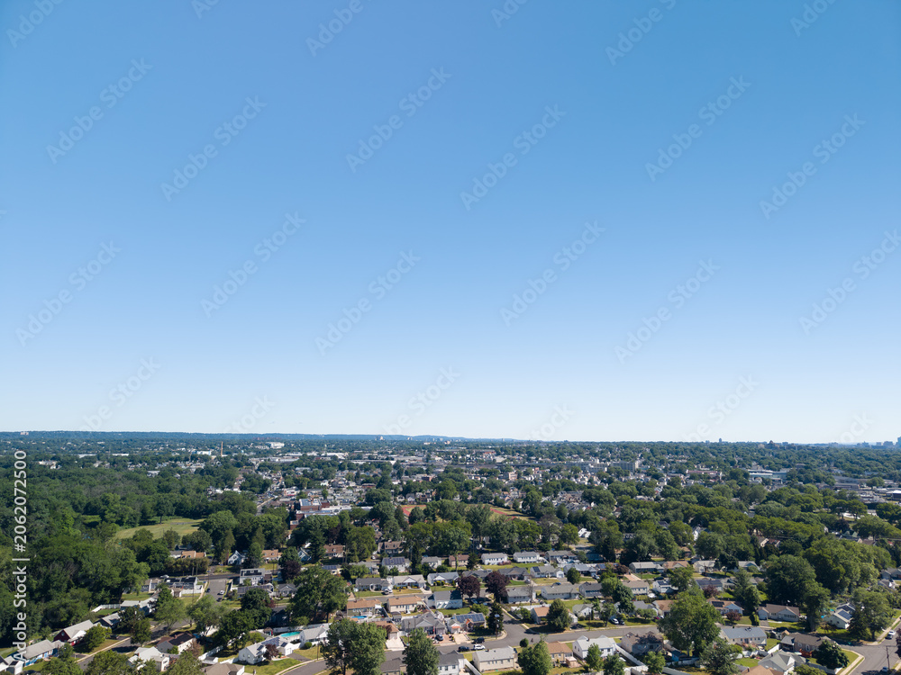 Fototapeta premium Aerial view showing residential suburbia and blue sky