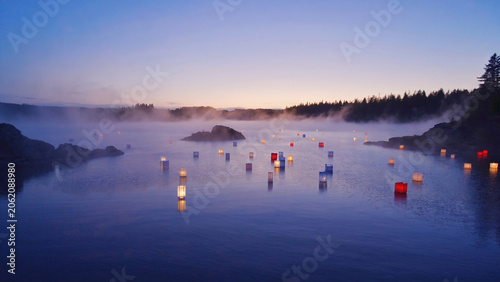 red candles floating on lake at night landscape.ai 