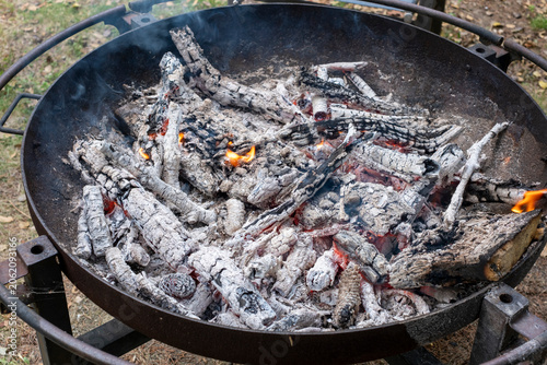 Фотография Hot Glowing Embers and White Ash inside Metal Fire Pit