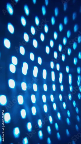 Abstract blue glowing dot matrix background with blurred neon lights. A digital technology pattern loop with soft bokeh, ideal for futuristic, cyber, and nightclub stage backdrops.