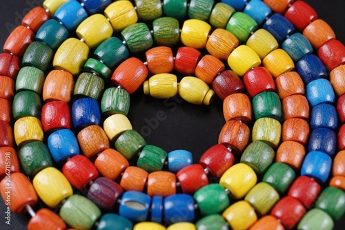 A pile of colorful wooden beads sitting on top of a table