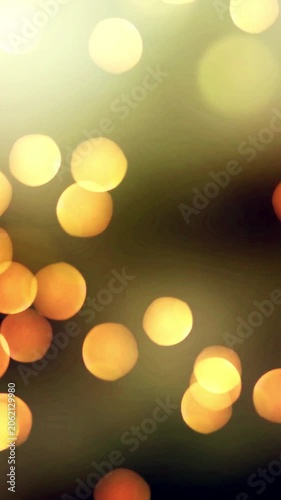 Golden warm bokeh background with glowing blurred circular lights, festive abstract texture in orange and yellow tones for holiday and event designs.