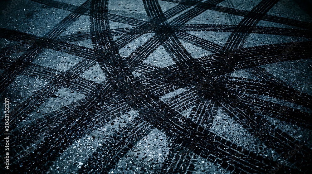 Obraz premium Abstract background of intersecting vehicle tire tracks on dark asphalt