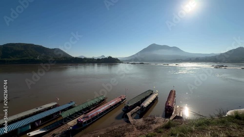 Traditional longboats moored on Mekong River at Kaeng Khut Khu, Thailand 