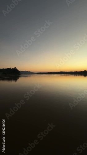 Vertical abstract golden sunset reflection on river
