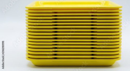 Group of durable, reusable plastic serving trays stacked neatly, symbolizing meal service, mass feeding, and institutional dining efficiency, organization, lunch, school