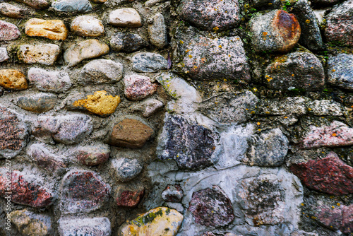 Weathered stones form a rugged, textured wall