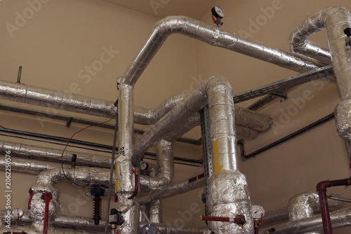 Industrial pipes gleam with reflective insulation