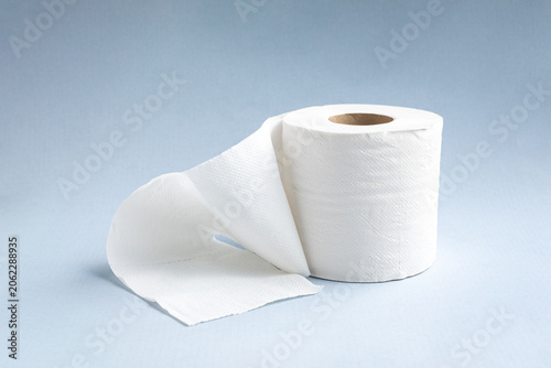 Toilet paper roll on light blue background.