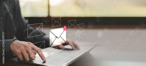 Photos Email notification and business communication concept with incoming message alerts on laptop