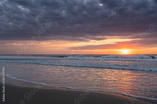Photography Dramatic sunrise over breaking waves on the beach in Corolla, North Carolina