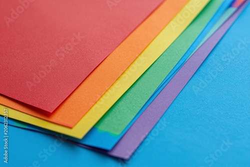 A bunch of different colored paper on a table