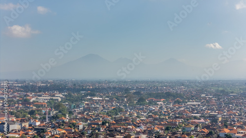 Billede på lærred High altitude drone aerial panorama of Denpasar city skyline with beautiful mountains and tropical volcanoes in the background, Bali, Indonesia