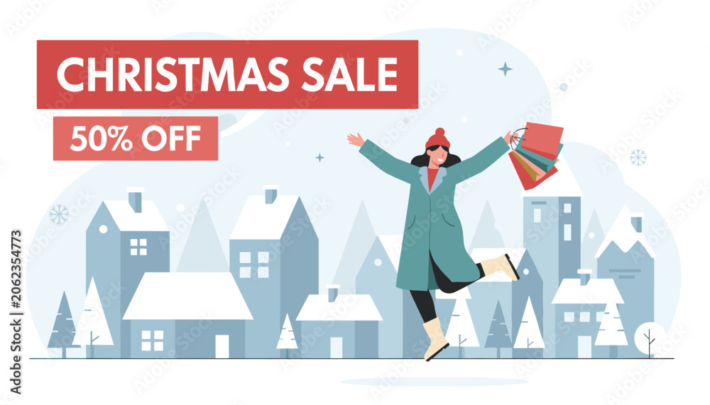 Fototapeta premium Happy woman with shopping bags jumping for joy in a snowy winter village with a Christmas sale fifty percent off banner in the sky.