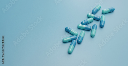 Foto Blue capsule pills on blue background
