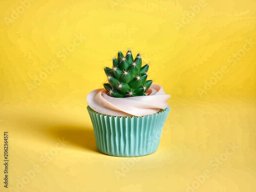 Cactus growing inside pastel blue cupcake surreal background