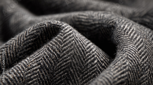 Close Up Texture of Charcoal Grey Herringbone Tweed Fabric Background