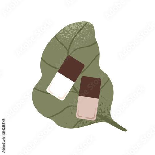 Eco-friendly nail polish bottles on green plant leaf. Natural beauty and orga...