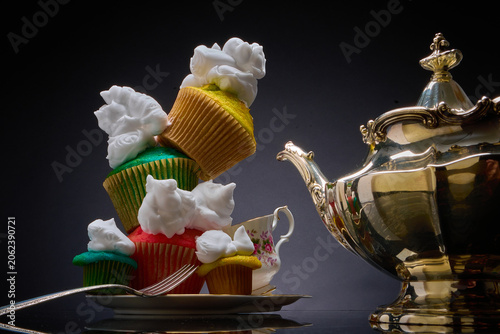Foto Teetering, colorful, cupcakes, whipped cream & teacup
