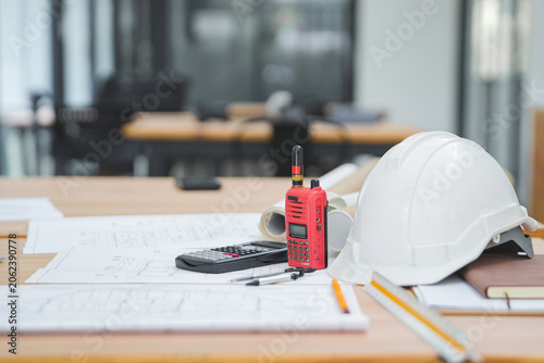 Construction Tools and Equipment on a Desk with Blueprints and a