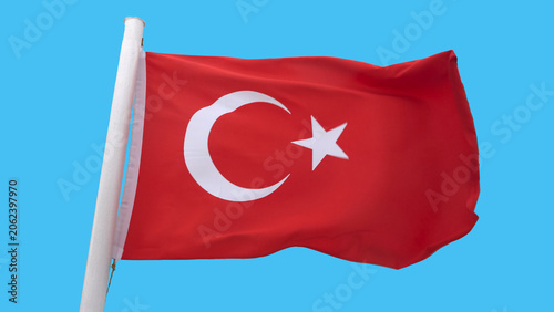 Turkish flag waving in the wind isolated on solid blue background