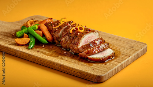 Sliced Duck Breast with Orange Honey Glaze, Roasted Vegetables and Citrus Zest in Vibrant BBQ Scene