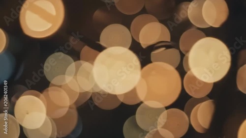 Soft, out-of-focus bokeh lights twinkling gently in warm orange and yellow tones.