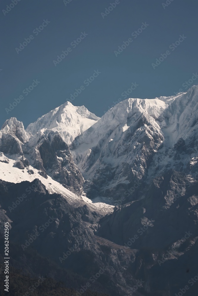 Fototapeta premium Snow-Capped Mountain Peaks Above Rocky Alpine Slopes