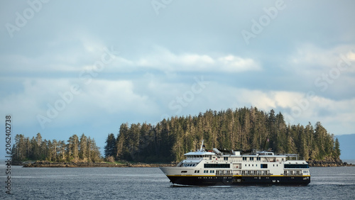 Small expedition cruiseship cruise ship liner National Geographic Venture sailing cruising Alaska Inside Passage with breathtaking Last Frontier mountain and Fjord nature landscape scenery