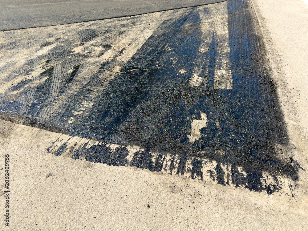 Fototapeta premium Fresh asphalt shows wear and faded markings