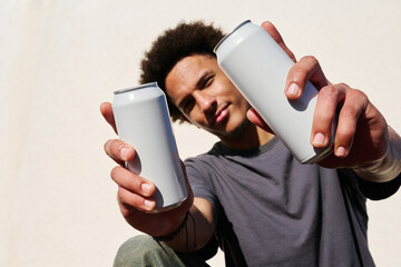 Man holding two cans