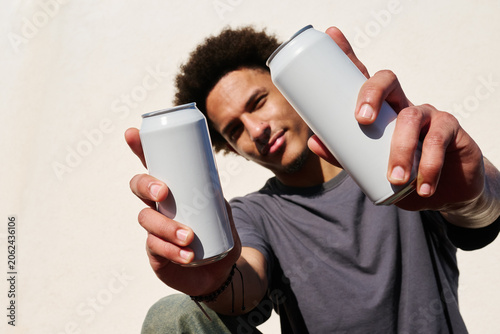 Man holding two cans