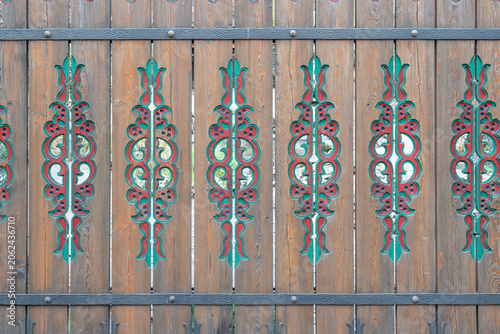 Wooden fence with colorful patterns in a village