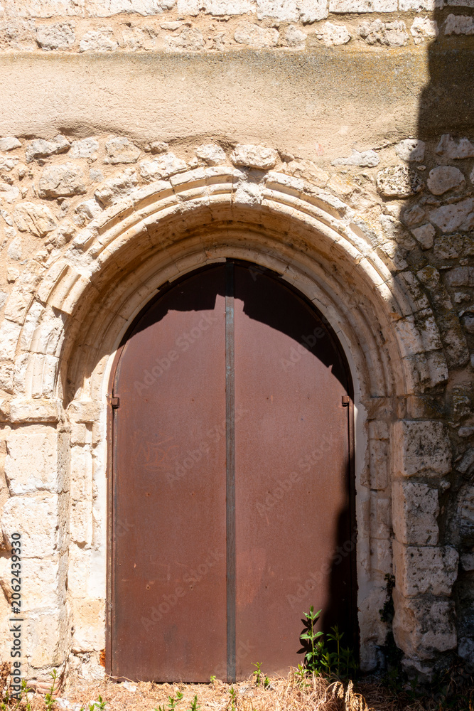 Fototapeta premium Architectural view of the 13th-century Cistercian portal connecting the former cloister with the church at the Monastery of Santa Maria de Palazuelos in Corcos del Valle, Valladolid, Castilla y Leon