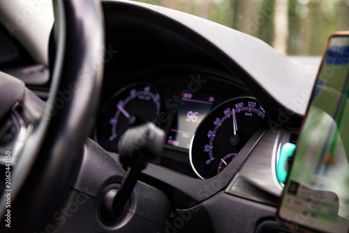Принти на полотні Driving Car With Speedometer Showing Speed and Phone Navigation System During Da