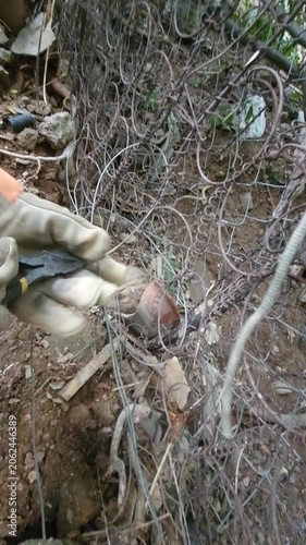 Close Up of Gloved Hands Tying Secure Knots and Wire Binding Outdoors