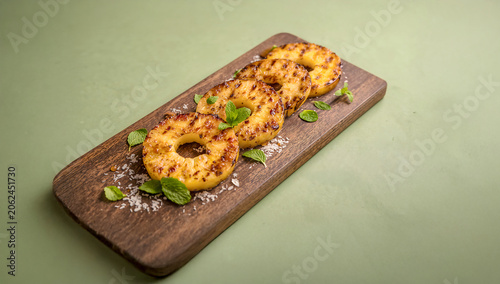 Toasted Coconut and Mint Pineapple Slices with Caramel Glaze in Photorealistic Green Background BBQ Scene