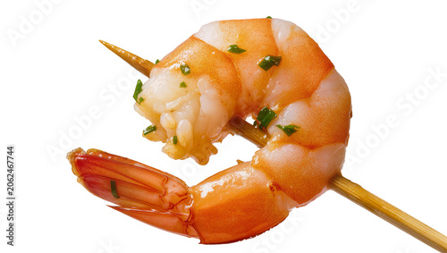 Cooked shrimp on wooden skewer with chopped herbs