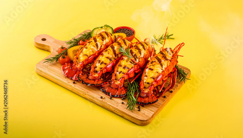 Grilled Lobster Halves with Butter and Herbs on Wooden Board in Vibrant Yellow BBQ Braai Food Scene