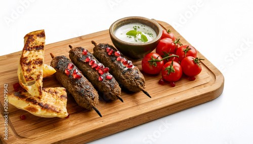Lamb Koftas with Grilled Flatbread and Mint Yogurt on Rustic Board Clean White BBQ Barbecue Braai Setting