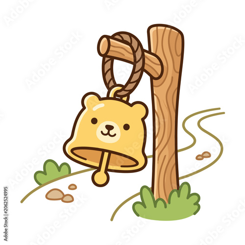 A cute yellow bear bell hangs on a wooden post by a path