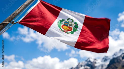 National flag of Peru with coat of arms waving on wooden pole under blue sky