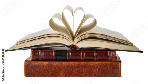 Fotografie Open book with pages forming heart shape on stack of antique leather-bound books