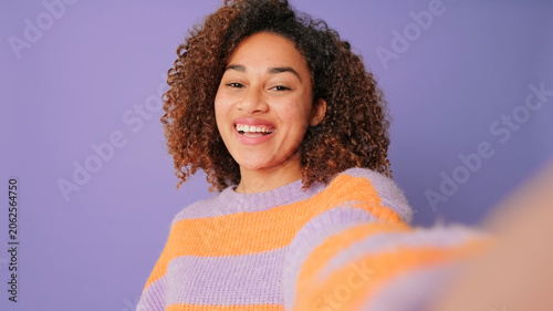 Bild auf Leinwand Smiling Woman Selfie In Colorful Striped Sweater