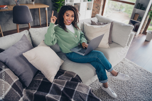Obraz na plátně Full size photo of attractive young woman wit couch netbook eureka dressed green